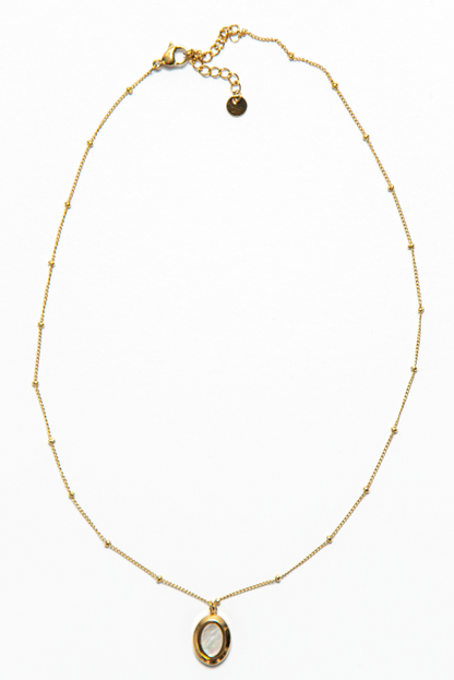 The Kate Necklace is adorned with an oval-shaped pendant that adds a pop of charm and personality to the piece. 