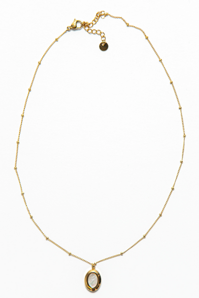 The Kate Necklace is adorned with an oval-shaped pendant that adds a pop of charm and personality to the piece. 