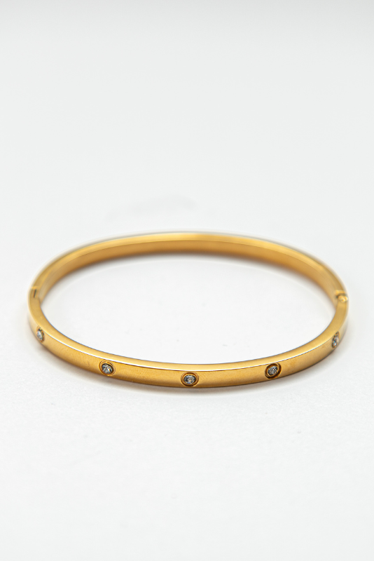 This elegant bangle features sparkling cubic zirconia stones that catch the light beautifully and add a touch of glamour to any outfit. 